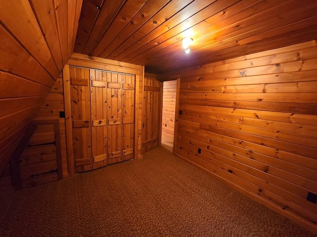 additional living space with wooden ceiling, carpet floors, and wooden walls