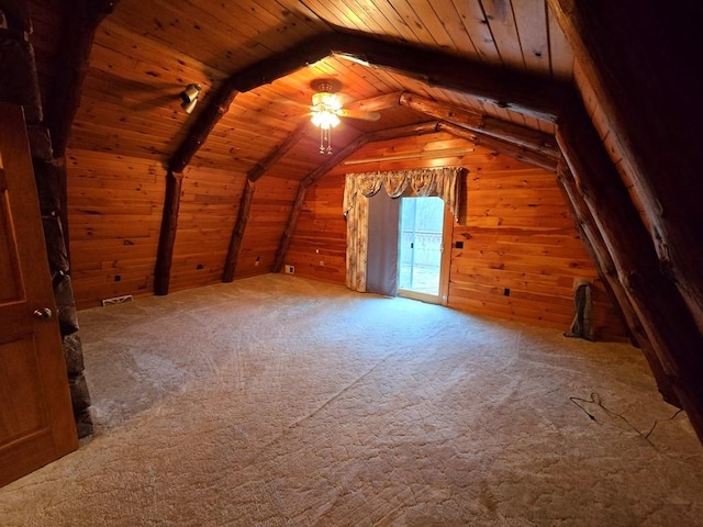 bonus room with carpet flooring, ceiling fan, lofted ceiling, wooden walls, and wood ceiling