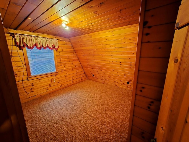 interior space featuring wooden walls, carpet floors, wood ceiling, and lofted ceiling