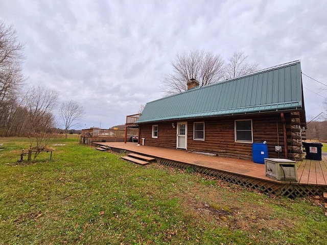 back of property featuring a lawn and a deck