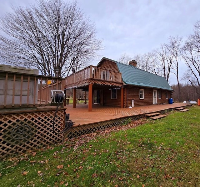 back of property featuring a lawn and a deck