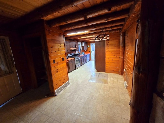 interior space with beamed ceiling, wood walls, and wooden ceiling