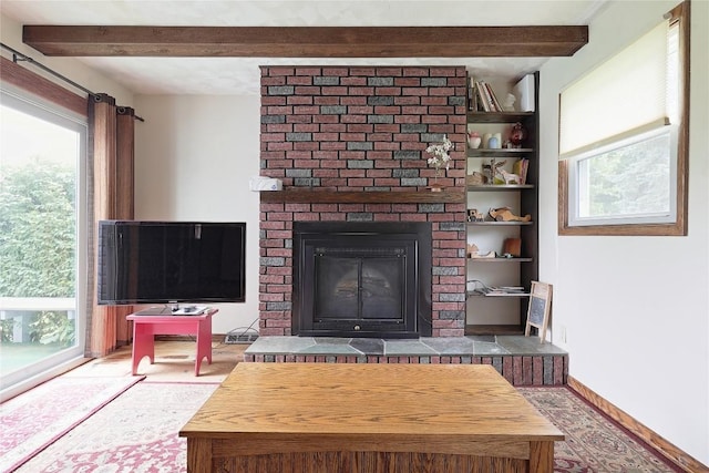 5219 W 52nd St, Fairview, PA 16415 - living room featuring beamed ceiling, healthy amount of natural light, a brick fireplace, and wood finished floors