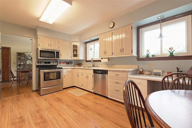 5219 W 52nd St, Fairview, PA 16415 - kitchen with appliances with stainless steel finishes, light countertops, plenty of natural light, and light wood finished floors