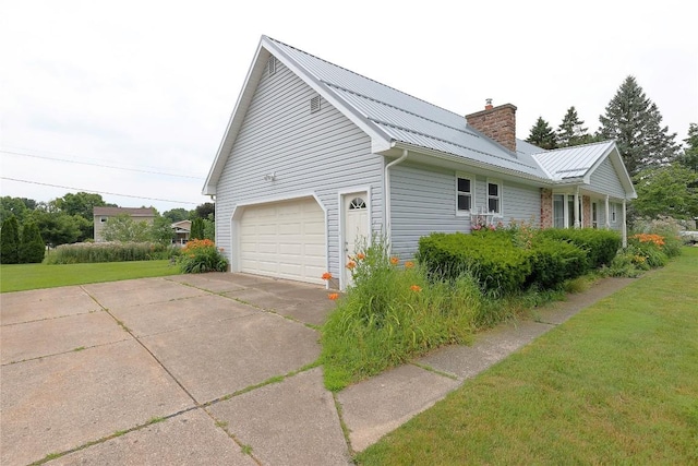5219 W 52nd St, Fairview, PA 16415 - view of home's exterior with a chimney, driveway, an attached garage, a metal roof, and a yard