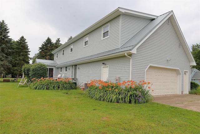5219 W 52nd St, Fairview, PA 16415 - view of property exterior featuring a garage, a lawn, driveway, and a metal roof