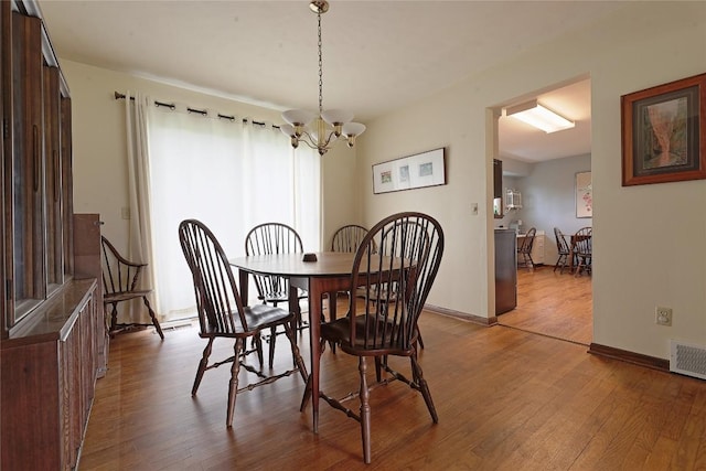 5219 W 52nd St, Fairview, PA 16415 - dining area with wood finished floors and a chandelier