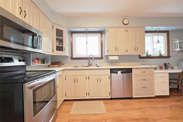 5219 W 52nd St, Fairview, PA 16415 - kitchen featuring stainless steel appliances, light countertops, light wood-type flooring, light brown cabinets, and decorative light fixtures