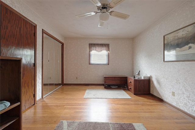 5219 W 52nd St, Fairview, PA 16415 - unfurnished bedroom with light wood-style floors, wallpapered walls, and ceiling fan