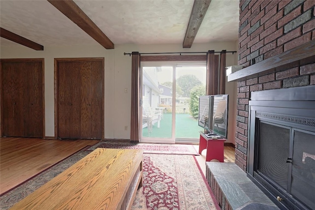 5219 W 52nd St, Fairview, PA 16415 - living area featuring beam ceiling, wood finished floors, and a brick fireplace