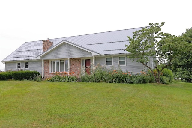 5219 W 52nd St, Fairview, PA 16415 - view of front of home featuring a front yard, a chimney, and a metal roof