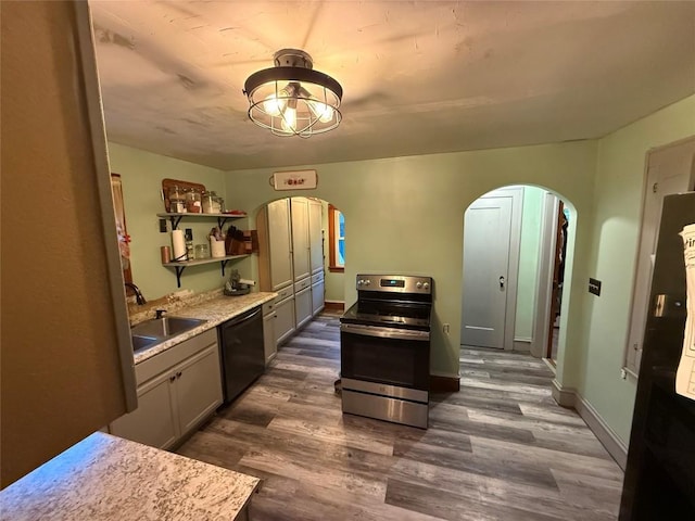 20743 Alden St, Meadville, PA 16335 - kitchen featuring stainless steel range with electric stovetop, arched walkways, dishwasher, a sink, and dark wood-type flooring