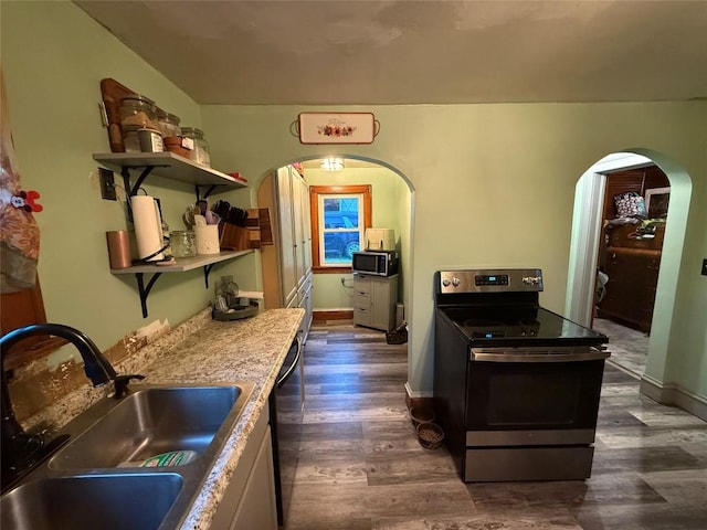 20743 Alden St, Meadville, PA 16335 - kitchen with stainless steel appliances, a sink, arched walkways, dark wood finished floors, and open shelves