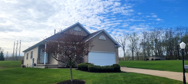 view of side of property featuring concrete driveway, a yard, and brick siding