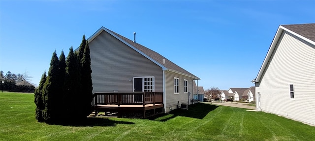 rear view of property with a wooden deck, a yard, and central AC
