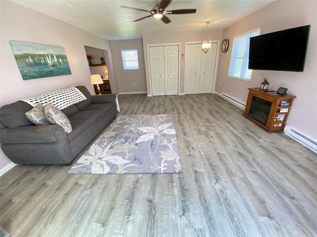 1986 Providence Dr, Jamestown, PA 16134 - living room with a ceiling fan, baseboards, a baseboard heating unit, and wood finished floors
