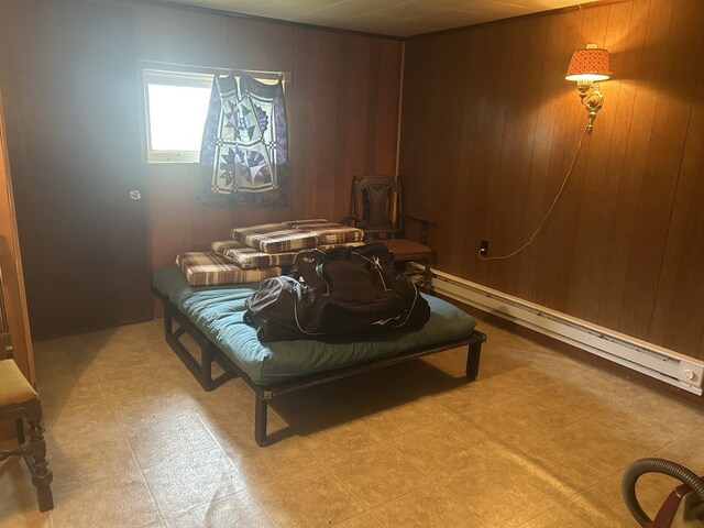 1402 Hickory St, Espyville, PA 16424 - bedroom featuring light floors, baseboard heating, a wood stove, and wooden walls