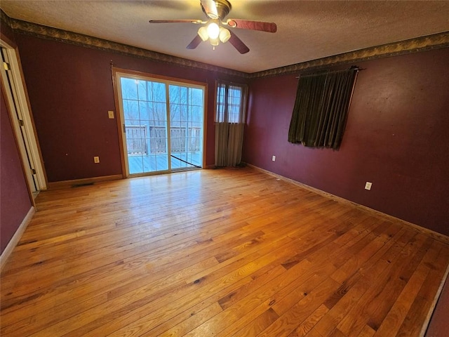 unfurnished room with ceiling fan, a textured ceiling, and light hardwood / wood-style flooring