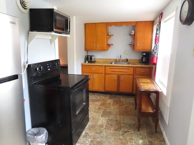 kitchen with plenty of natural light, sink, and stainless steel appliances