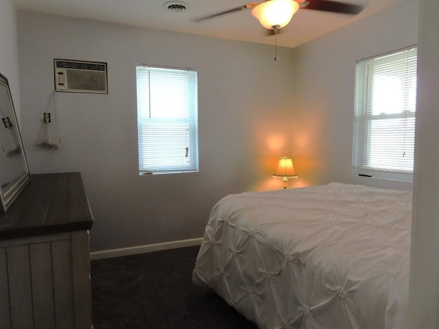 bedroom featuring a wall mounted air conditioner, dark colored carpet, and ceiling fan