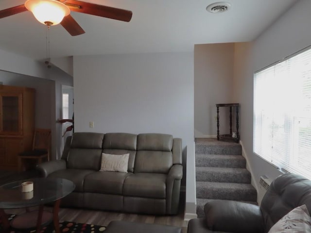 living room featuring ceiling fan and a healthy amount of sunlight