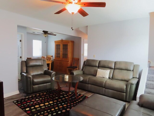 living room featuring ceiling fan and light hardwood / wood-style floors