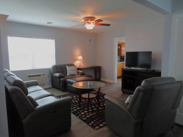 living room featuring a wall mounted AC, ceiling fan, and light hardwood / wood-style floors