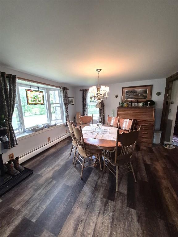 23754 S Beaver Rd, Springboro, PA 16435 - dining space featuring a baseboard heating unit, wood finished floors, and a chandelier
