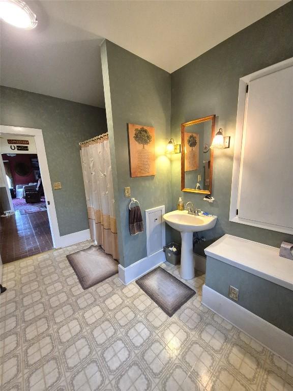 23754 S Beaver Rd, Springboro, PA 16435 - full bathroom featuring baseboards and a sink