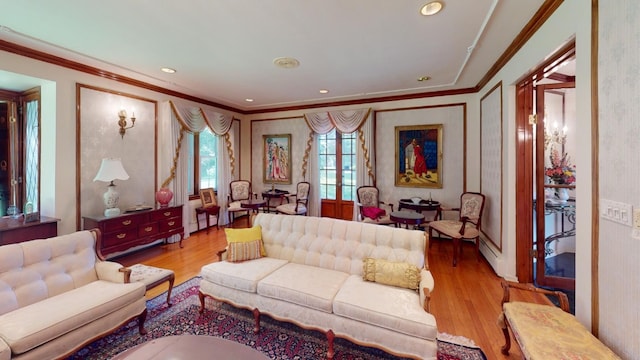 living room with light hardwood / wood-style flooring and ornamental molding