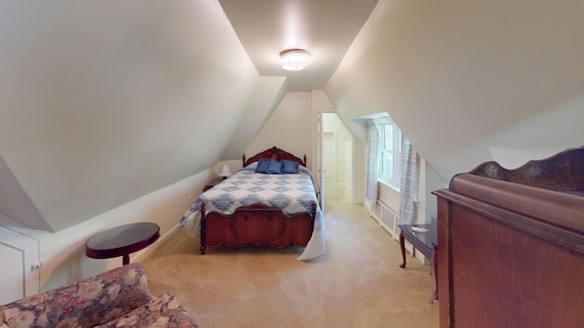 bedroom with light colored carpet and lofted ceiling