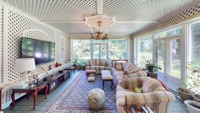 sunroom / solarium with a healthy amount of sunlight and a chandelier