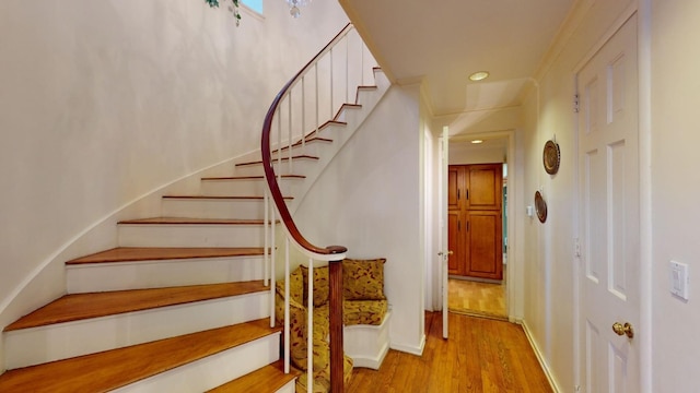 stairs featuring hardwood / wood-style flooring