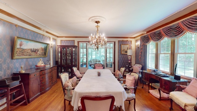 dining room featuring light hardwood / wood-style floors, a wealth of natural light, and crown molding