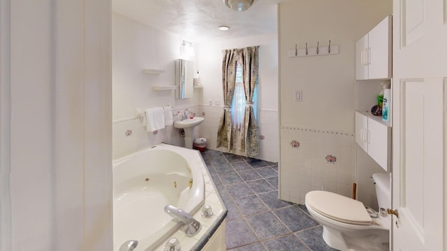 bathroom with tile patterned flooring, toilet, tile walls, and a tub