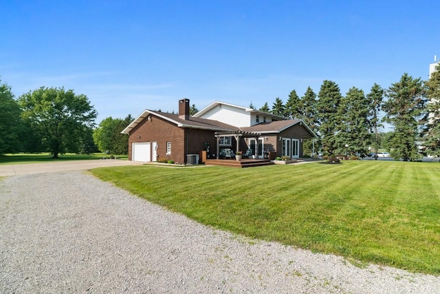5124 W Ridge Rd, Erie, PA 16506 - rear view of property featuring driveway, a garage, a chimney, brick siding, and a lawn