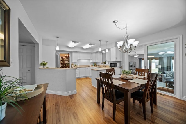 5124 W Ridge Rd, Erie, PA 16506 - dining area featuring a chandelier, light wood-style floors, and plenty of natural light