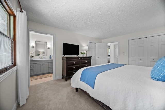 5124 W Ridge Rd, Erie, PA 16506 - bedroom featuring light colored carpet, ensuite bath, two closets, and a textured ceiling