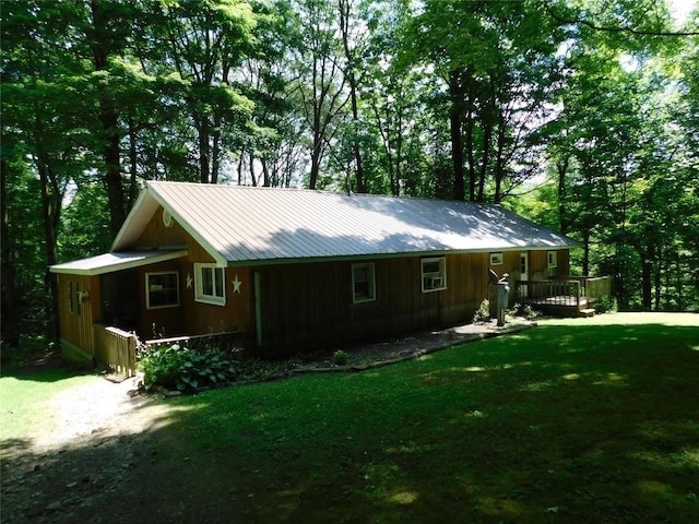 15954 Parsons Ln, Edinboro, PA 16412 - view of property exterior featuring a lawn, board and batten siding, a deck, and a metal roof