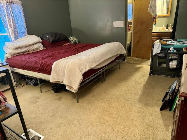 bedroom with light colored carpet