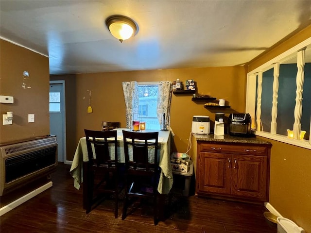 dining room with dark wood-type flooring and heating unit