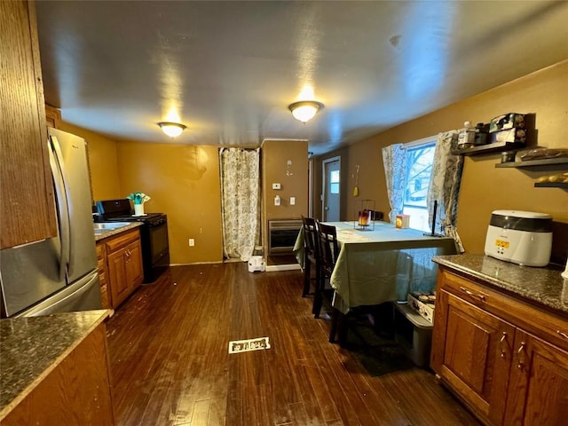 bedroom with dark wood-type flooring and stainless steel fridge