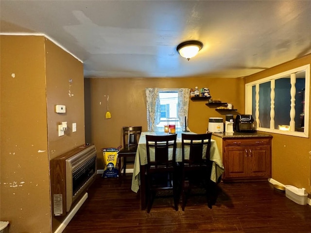 dining area featuring dark hardwood / wood-style floors and heating unit