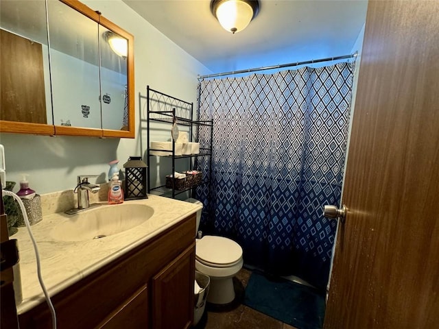 bathroom with toilet, vanity, and a shower with curtain