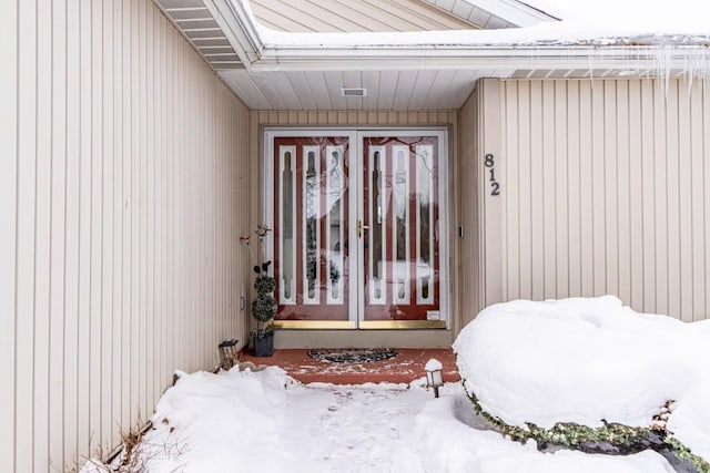 view of snow covered property entrance