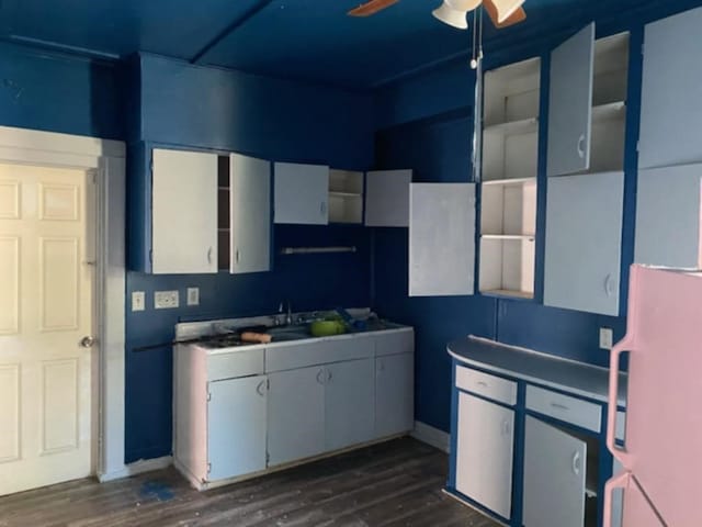 kitchen featuring ceiling fan, refrigerator, white cabinetry, and dark wood-type flooring