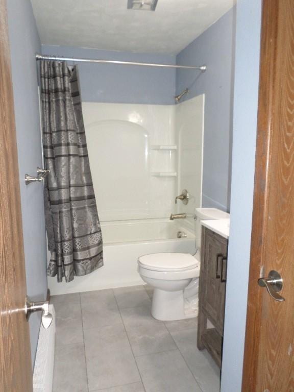 full bathroom featuring tile patterned flooring, vanity, toilet, and shower / bathtub combination with curtain