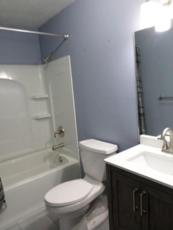 full bathroom featuring tile patterned floors, vanity, toilet, and shower / tub combination