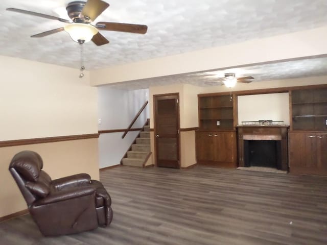 living area with a fireplace and dark hardwood / wood-style floors