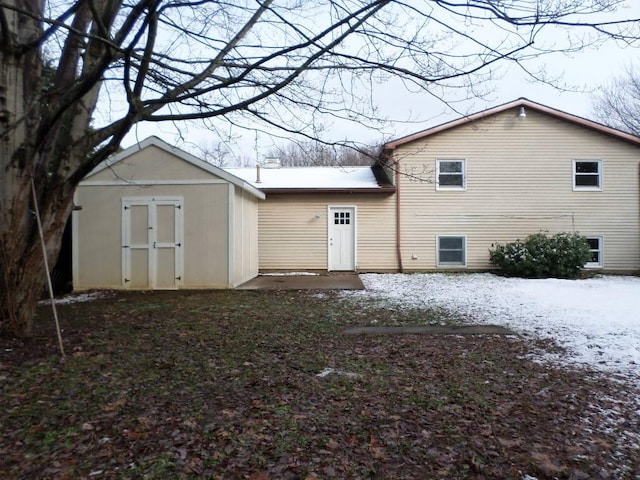 view of snow covered back of property